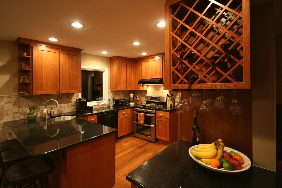 Exempel på ett mellanstort amerikanskt kök, med skåp i shakerstil, granitbänkskiva, beige stänkskydd, stänkskydd i stenkakel, en enkel diskho, skåp i mellenmörkt trä, rostfria vitvaror och mellanmörkt trägolv