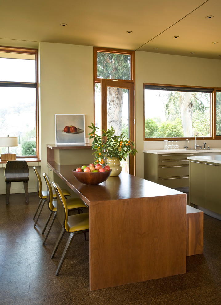 This is an example of a modern kitchen in Los Angeles with flat-panel cabinets and green cabinets.