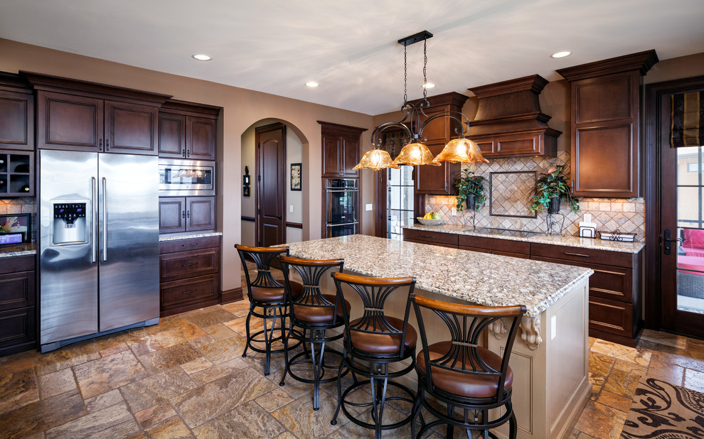 Mid-sized elegant u-shaped ceramic tile eat-in kitchen photo in Grand Rapids with an undermount sink, recessed-panel cabinets, dark wood cabinets, granite countertops, multicolored backsplash, ceramic backsplash, colored appliances and an island