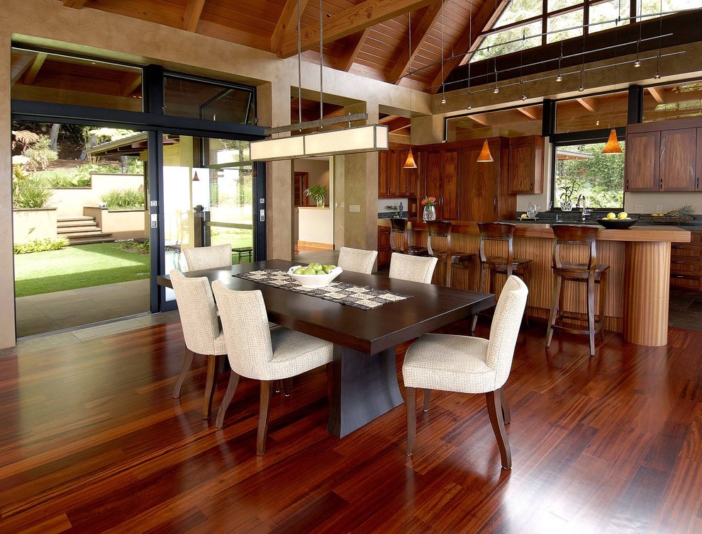 Photo of a large world-inspired u-shaped open plan kitchen in Hawaii with a submerged sink, recessed-panel cabinets, medium wood cabinets, wood worktops, beige splashback, integrated appliances, dark hardwood flooring, an island, brown floors and brown worktops.