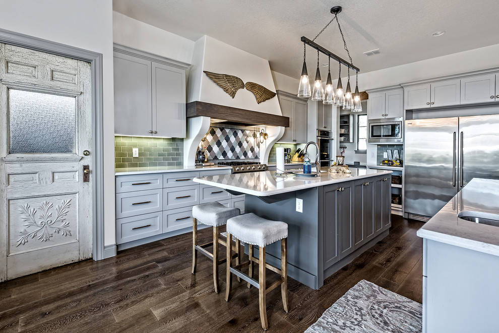 Inspiration for a classic galley open plan kitchen in Austin with a submerged sink, shaker cabinets, grey cabinets, grey splashback, stainless steel appliances, medium hardwood flooring and multiple islands.