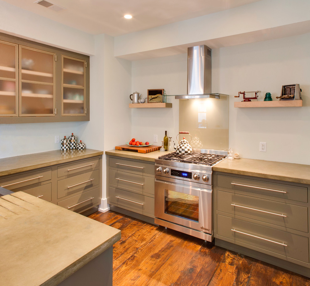 Trendy kitchen photo in Atlanta with flat-panel cabinets, beige cabinets, concrete countertops, beige backsplash, glass sheet backsplash and stainless steel appliances