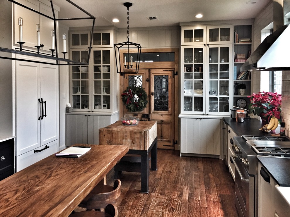 Photo of a traditional kitchen in Dallas with a belfast sink, shaker cabinets, granite worktops and dark hardwood flooring.