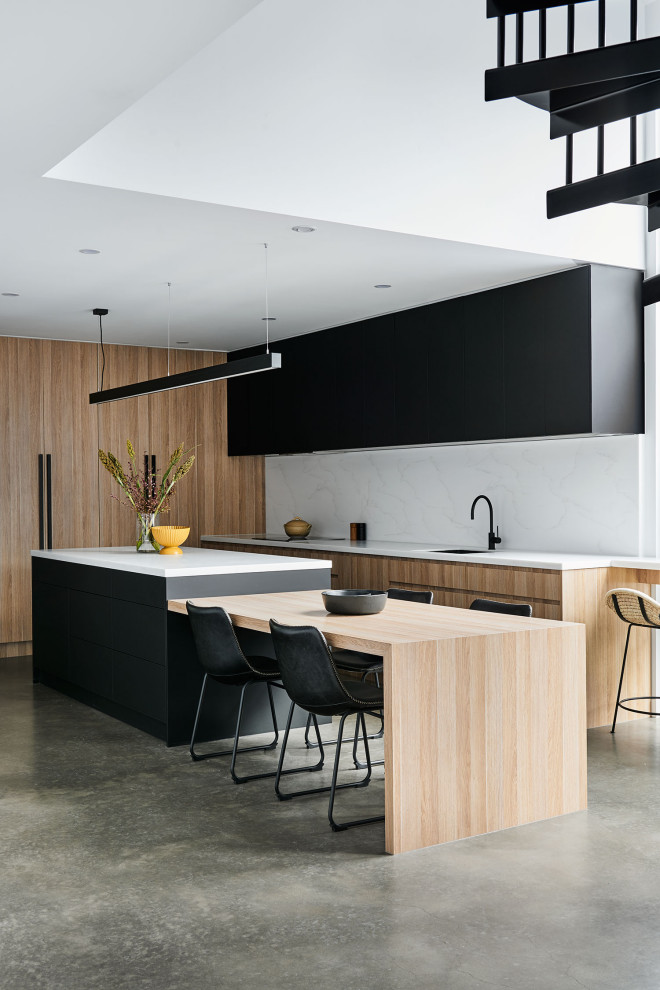Small contemporary l-shaped kitchen/diner in Geelong with a submerged sink, light wood cabinets, engineered stone countertops, white splashback, engineered quartz splashback, stainless steel appliances, concrete flooring, an island, grey floors and white worktops.