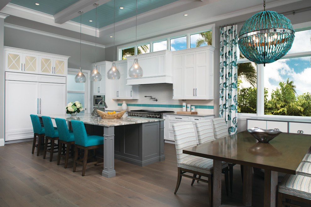 Inspiration for a large coastal u-shaped dark wood floor and brown floor eat-in kitchen remodel in Miami with shaker cabinets, white cabinets, granite countertops, paneled appliances, an island, an undermount sink, white backsplash, mosaic tile backsplash and gray countertops