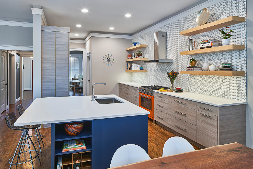 This is an example of a medium sized contemporary galley kitchen/diner in Charlotte with a submerged sink, flat-panel cabinets, grey cabinets, engineered stone countertops, white splashback, mosaic tiled splashback, dark hardwood flooring, an island, brown floors, white worktops and coloured appliances.