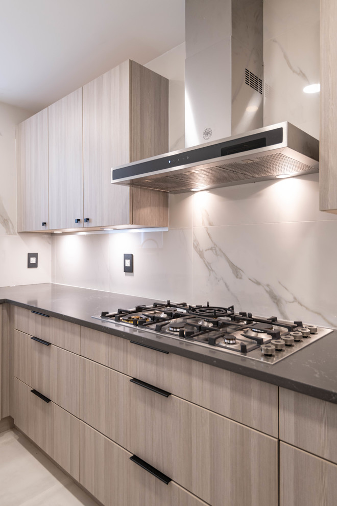 Mid-sized trendy l-shaped porcelain tile and white floor kitchen pantry photo in Vancouver with an undermount sink, flat-panel cabinets, brown cabinets, quartz countertops, white backsplash, porcelain backsplash, stainless steel appliances, no island and gray countertops