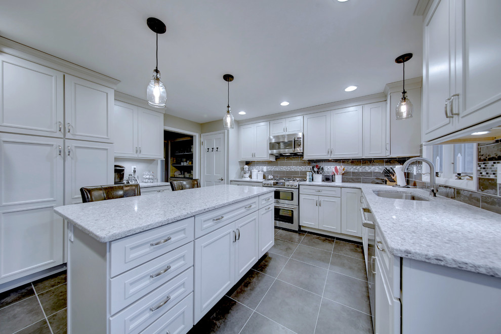 Large transitional u-shaped vinyl floor and gray floor kitchen photo in Other with quartz countertops, gray backsplash, mosaic tile backsplash, an island, an undermount sink, beaded inset cabinets, white cabinets and stainless steel appliances