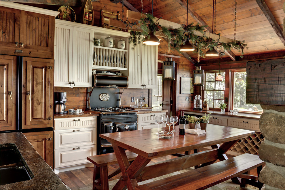 Inspiration for a rustic l-shaped eat-in kitchen remodel in Minneapolis with raised-panel cabinets, medium tone wood cabinets and black appliances