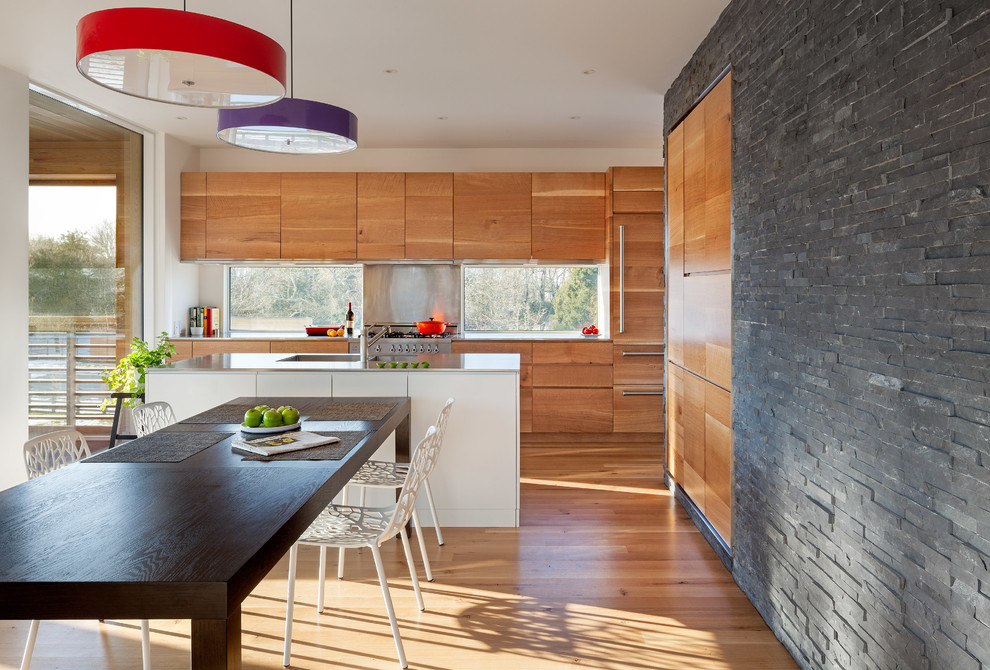 Inspiration for a contemporary galley kitchen/diner in Providence with an integrated sink, flat-panel cabinets, medium wood cabinets, stainless steel worktops, metal splashback, metallic splashback and integrated appliances.