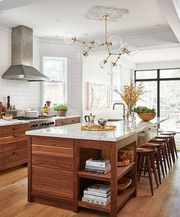 Large trendy l-shaped light wood floor and brown floor eat-in kitchen photo in Columbus with an undermount sink, flat-panel cabinets, medium tone wood cabinets, marble countertops, white backsplash, subway tile backsplash, stainless steel appliances, an island and white countertops