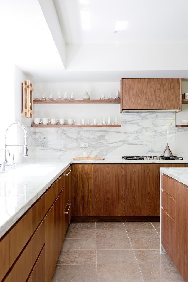 Inspiration for a large contemporary l-shaped ceramic tile and beige floor eat-in kitchen remodel in Columbus with an undermount sink, flat-panel cabinets, medium tone wood cabinets, quartz countertops, white backsplash, marble backsplash, black appliances, an island and white countertops