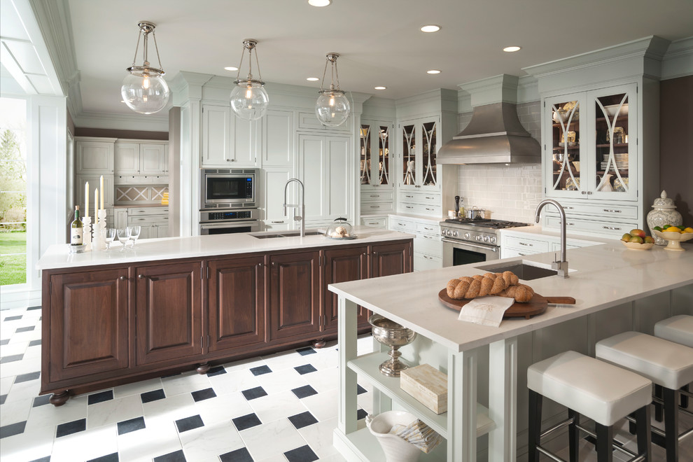 Large transitional u-shaped cement tile floor and white floor eat-in kitchen photo in Providence with shaker cabinets, white cabinets, quartzite countertops, an island, an undermount sink, white backsplash, subway tile backsplash and stainless steel appliances