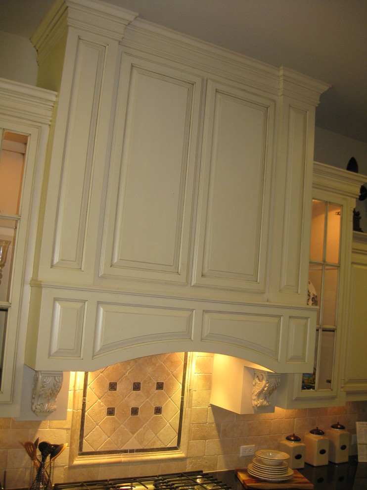 Wood range hood with acanthus corbels by Burrows Traditional