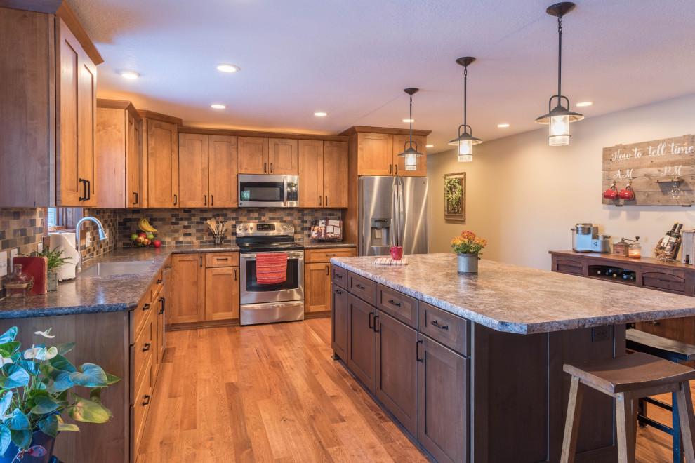 Example of a large arts and crafts l-shaped medium tone wood floor and brown floor eat-in kitchen design in Minneapolis with an undermount sink, shaker cabinets, medium tone wood cabinets, laminate countertops, multicolored backsplash, mosaic tile backsplash, stainless steel appliances, an island and turquoise countertops