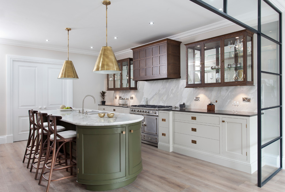 Traditional kitchen in West Midlands with a double-bowl sink, glass-front cabinets, dark wood cabinets, white splashback, marble splashback, stainless steel appliances, light hardwood flooring, an island and beige floors.