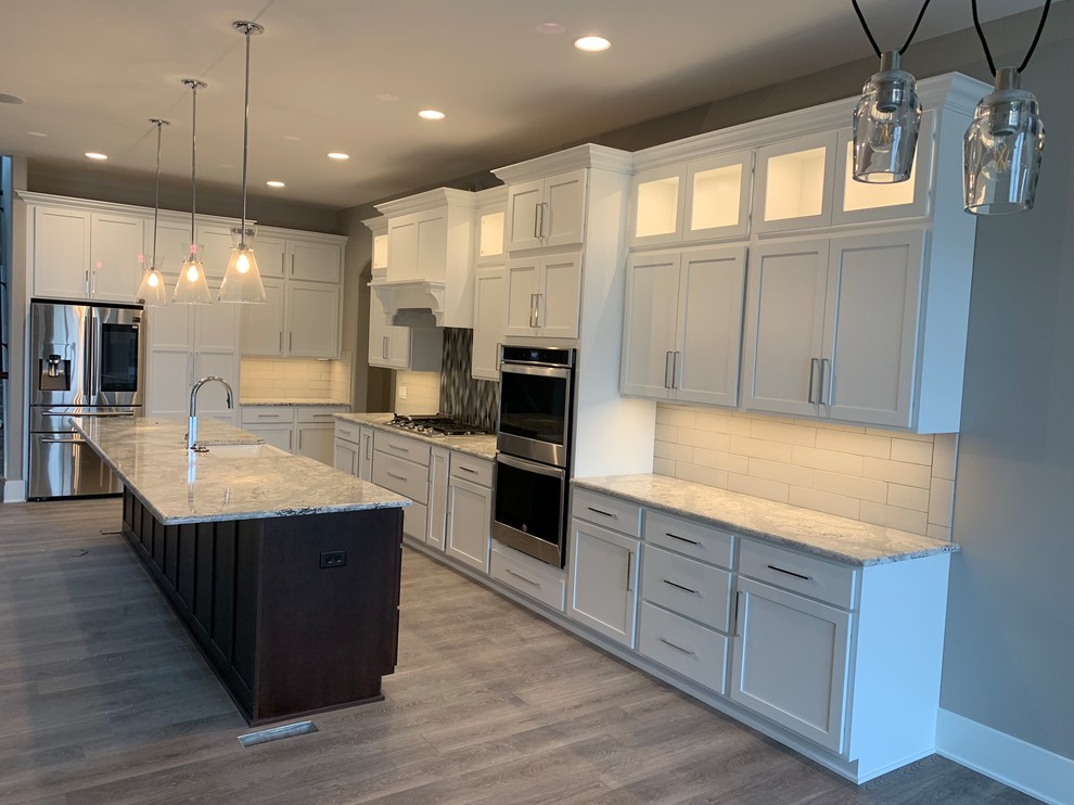 Inspiration for a classic kitchen in Omaha with shaker cabinets, white cabinets and an island.