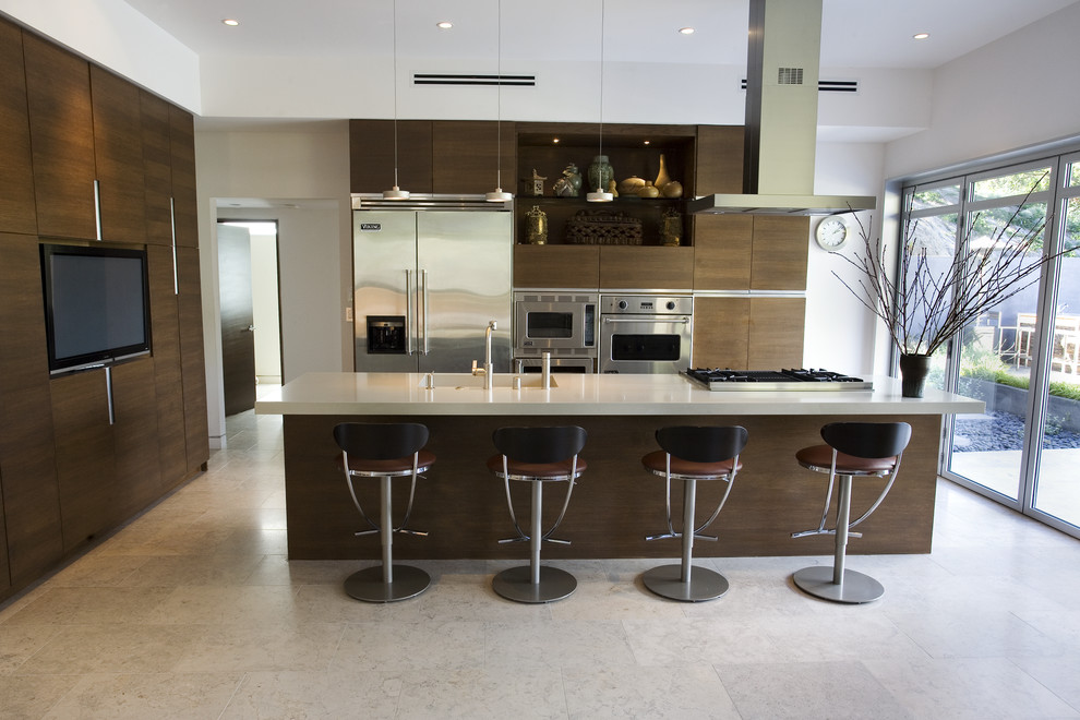 Esempio di una cucina moderna di medie dimensioni con lavello integrato, ante lisce, ante in legno bruno, top in superficie solida, elettrodomestici in acciaio inossidabile e pavimento in pietra calcarea
