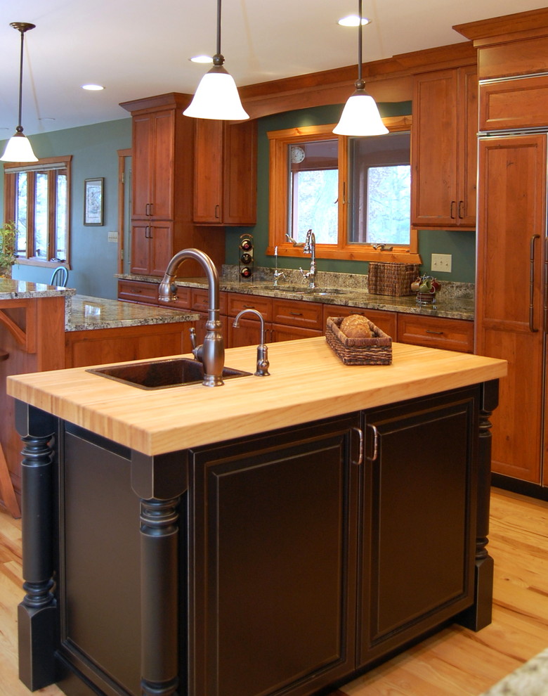 Photo of a medium sized rustic single-wall kitchen/diner in Chicago with a submerged sink, flat-panel cabinets, medium wood cabinets, granite worktops, stone slab splashback, integrated appliances, green splashback, light hardwood flooring and multiple islands.