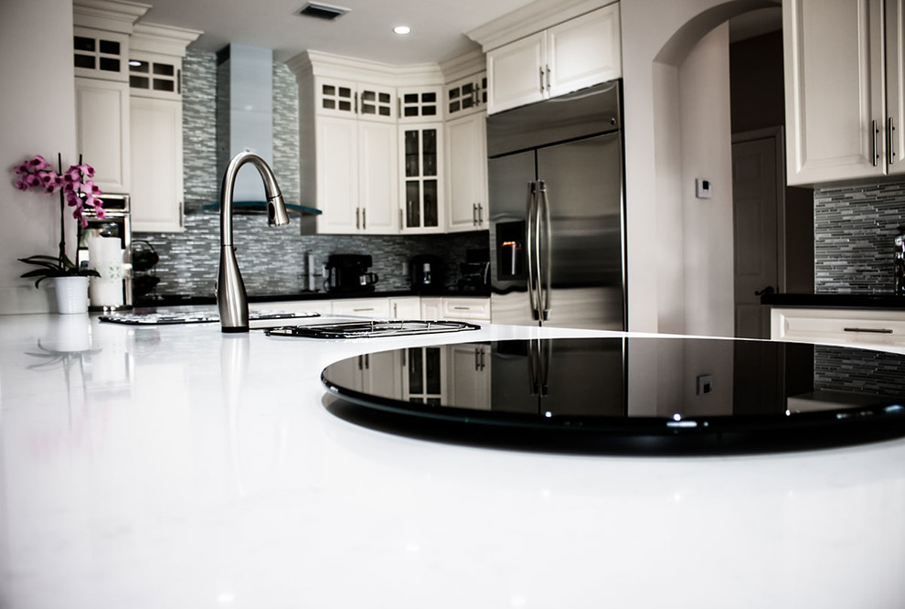 Inspiration for a medium sized contemporary u-shaped kitchen in Miami with a double-bowl sink, shaker cabinets, white cabinets, composite countertops, multi-coloured splashback, metal splashback, stainless steel appliances, marble flooring and an island.