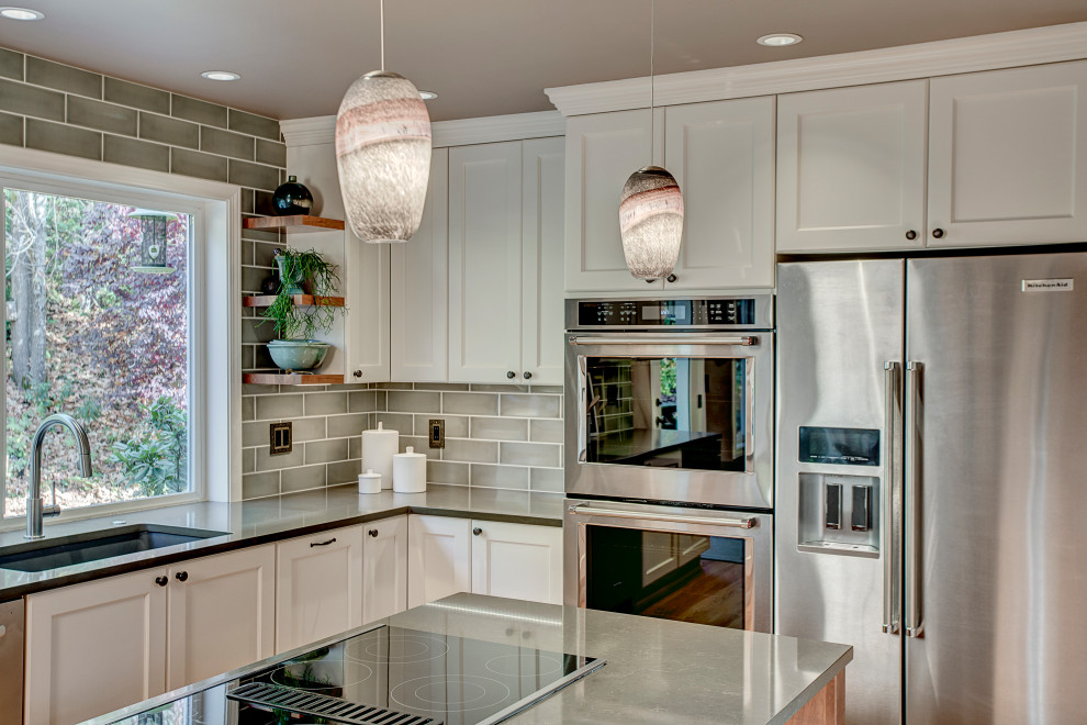 Photo of a medium sized traditional kitchen in Seattle with a submerged sink, recessed-panel cabinets, white cabinets, engineered stone countertops, green splashback, ceramic splashback, stainless steel appliances, medium hardwood flooring, an island, red floors and brown worktops.