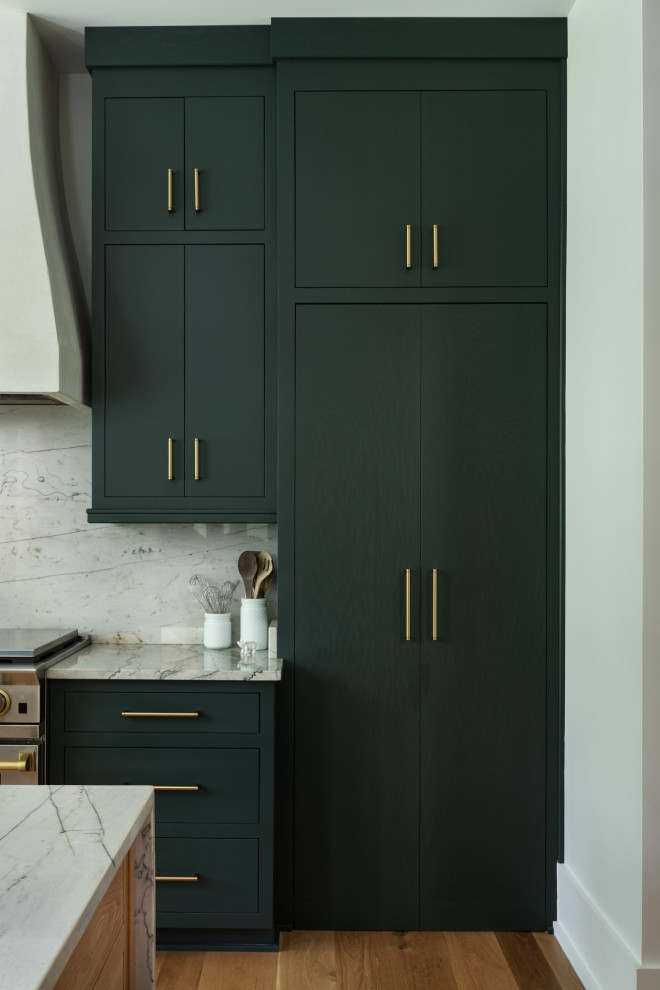 Lantlig inredning av ett stort grå grått kök, med en undermonterad diskho, släta luckor, gröna skåp, marmorbänkskiva, grått stänkskydd, stänkskydd i marmor, rostfria vitvaror, mellanmörkt trägolv, en köksö och brunt golv