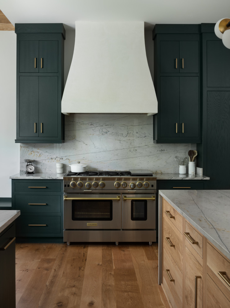 Inspiration for a large rural u-shaped kitchen pantry in New Orleans with a submerged sink, flat-panel cabinets, green cabinets, marble worktops, grey splashback, marble splashback, stainless steel appliances, medium hardwood flooring, an island, brown floors and grey worktops.