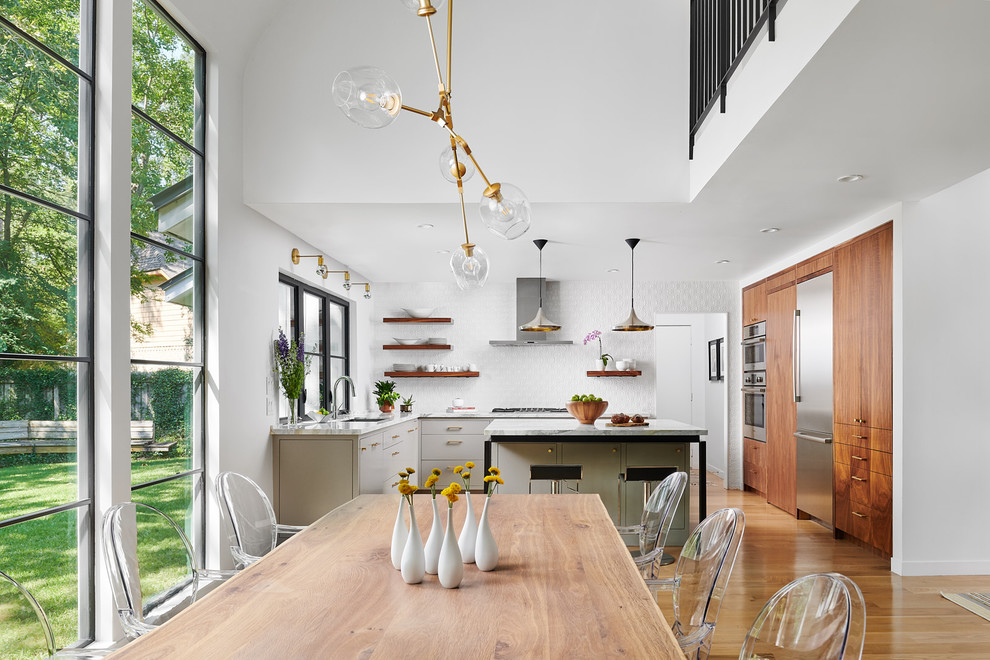 Inspiration for a mid-sized contemporary l-shaped light wood floor eat-in kitchen remodel in Houston with an undermount sink, flat-panel cabinets, gray cabinets, marble countertops, white backsplash, ceramic backsplash, stainless steel appliances, an island and white countertops