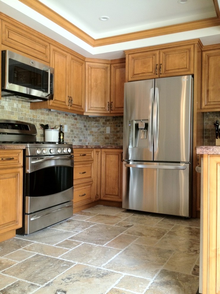 Example of a mid-sized trendy u-shaped ceramic tile enclosed kitchen design in Los Angeles with raised-panel cabinets, light wood cabinets, limestone countertops, multicolored backsplash, matchstick tile backsplash and stainless steel appliances