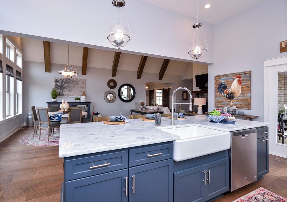 Inspiration for an expansive country l-shaped kitchen/diner in St Louis with shaker cabinets, blue cabinets, marble worktops, white splashback, metro tiled splashback, stainless steel appliances, an island and white worktops.