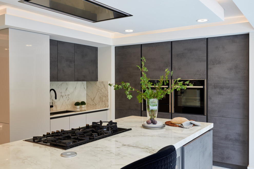 This is an example of a large contemporary l-shaped open plan kitchen in London with flat-panel cabinets, grey cabinets, marble worktops, grey splashback, marble splashback, black appliances, marble flooring, an island, grey floors and grey worktops.
