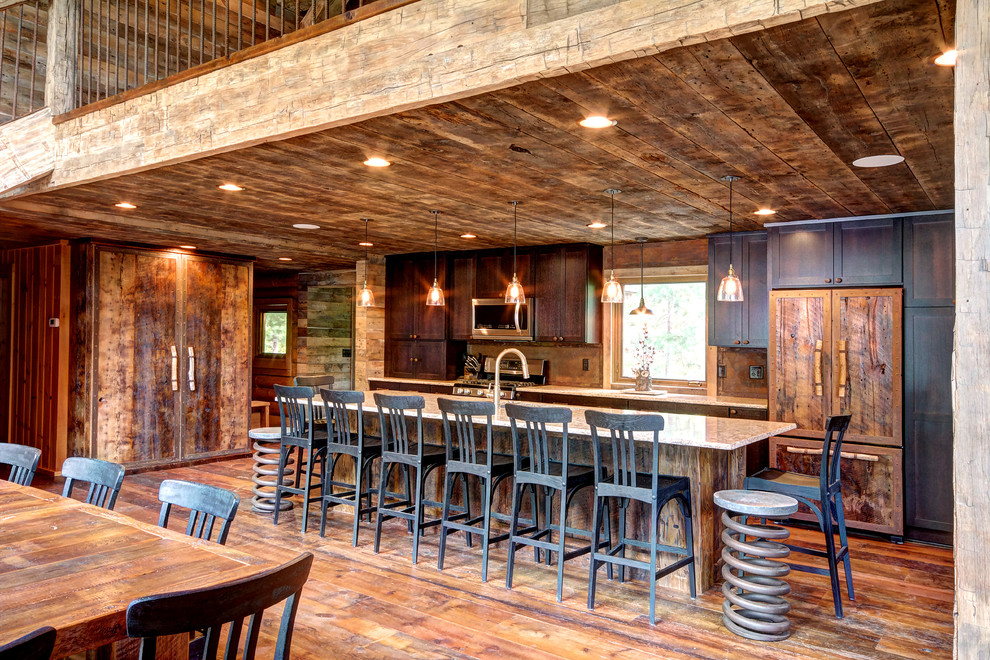 Inspiration for a rustic medium tone wood floor eat-in kitchen remodel in Other with shaker cabinets, dark wood cabinets, window backsplash, paneled appliances, an island and white countertops