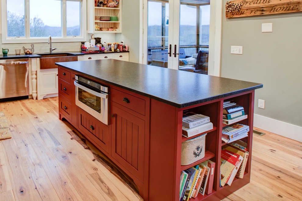 Eat-in kitchen - u-shaped light wood floor eat-in kitchen idea in Atlanta with shaker cabinets, red cabinets, solid surface countertops, stainless steel appliances and an island