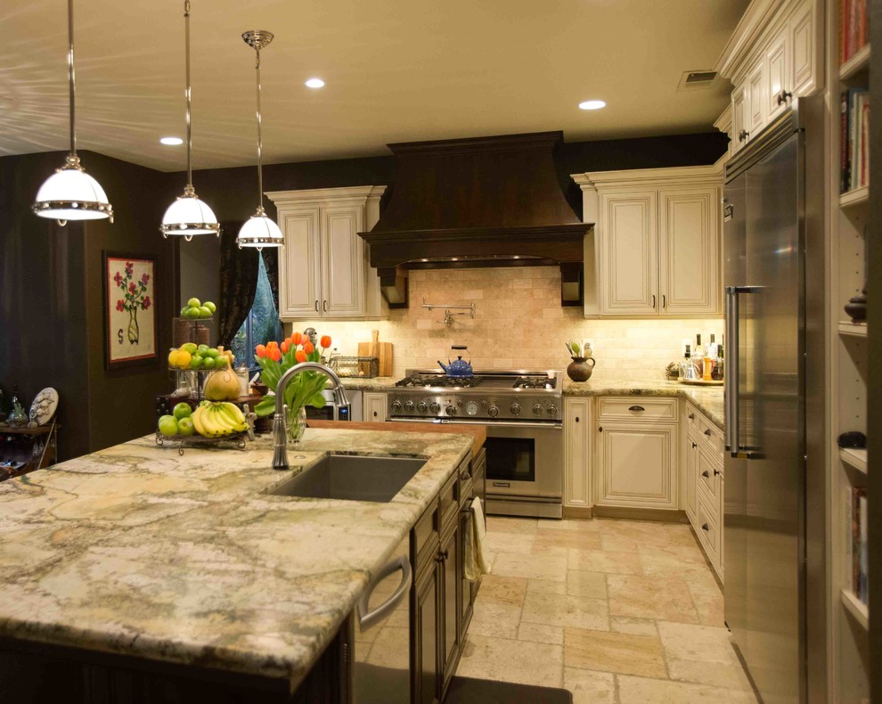 Large transitional l-shaped travertine floor and beige floor kitchen photo in Other with an undermount sink, raised-panel cabinets, white cabinets, quartzite countertops, beige backsplash, stone tile backsplash, stainless steel appliances and multicolored countertops