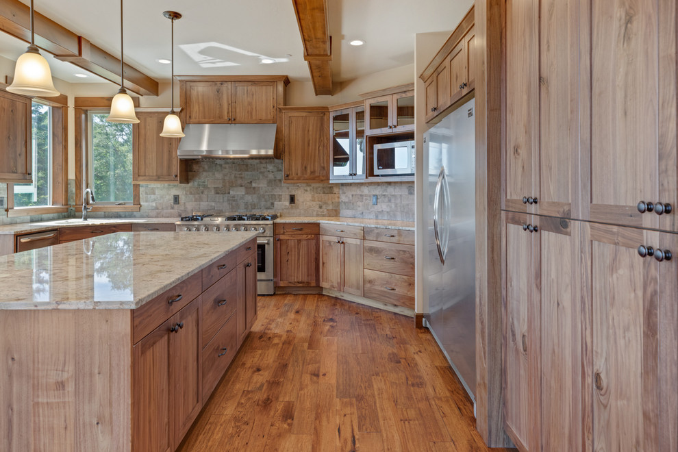 Example of a huge arts and crafts dark wood floor and brown floor eat-in kitchen design in Other with an undermount sink, shaker cabinets, dark wood cabinets, granite countertops, multicolored backsplash, brick backsplash, stainless steel appliances, an island and multicolored countertops