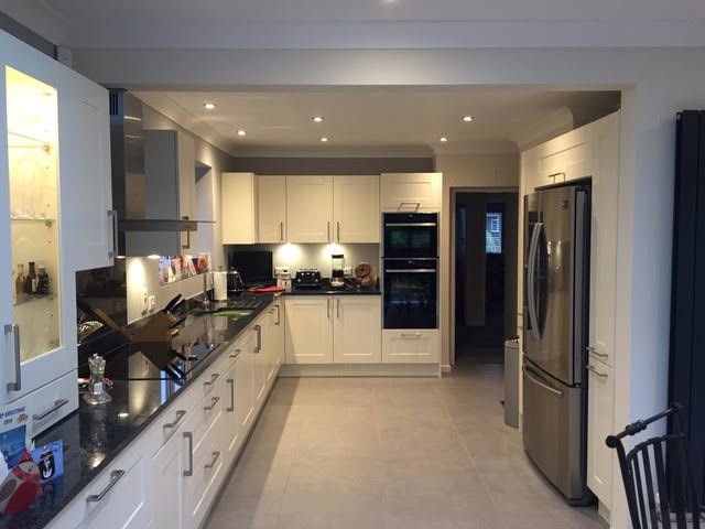 Inspiration for a small classic u-shaped open plan kitchen in Hampshire with a submerged sink, shaker cabinets, white cabinets, granite worktops, white splashback, ceramic splashback, stainless steel appliances, ceramic flooring and no island.