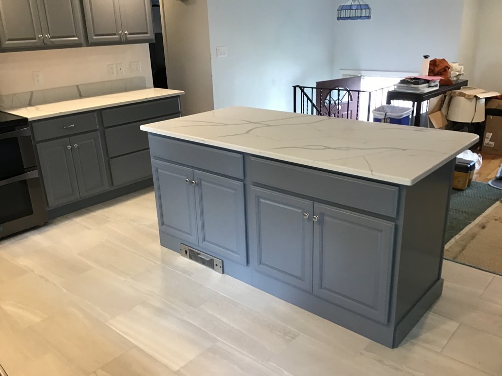 Design ideas for a medium sized classic l-shaped kitchen/diner in Boston with a submerged sink, raised-panel cabinets, grey cabinets, onyx worktops, black appliances, ceramic flooring, an island and white floors.