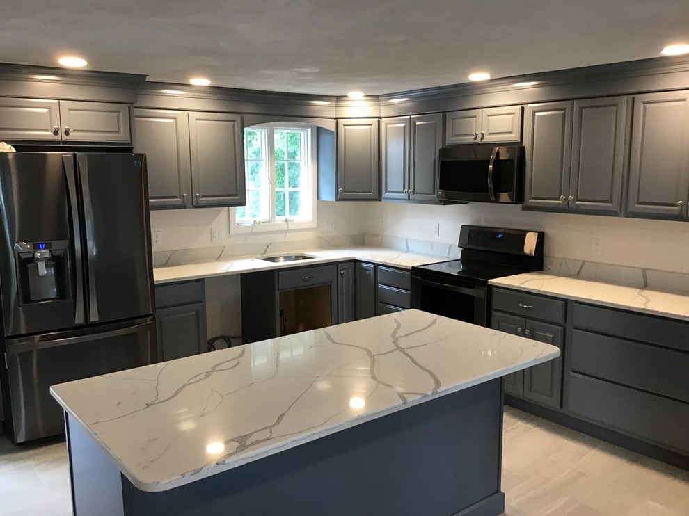 Photo of a medium sized classic l-shaped kitchen/diner in Boston with a submerged sink, raised-panel cabinets, grey cabinets, onyx worktops, black appliances, ceramic flooring, an island and white floors.
