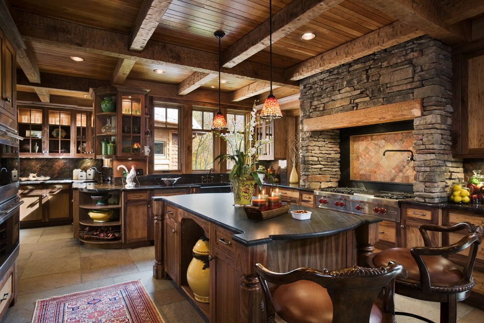 Cette image montre une cuisine traditionnelle en bois foncé avec un placard avec porte à panneau encastré et un électroménager en acier inoxydable.