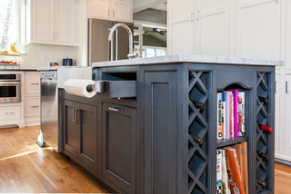 custom, built-in paper towel holder inside of white kitchen cabinets with  raised p…