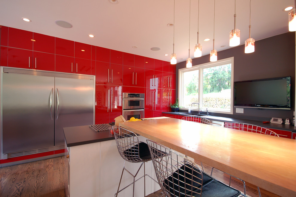 Eat-in kitchen - modern l-shaped dark wood floor eat-in kitchen idea in Minneapolis with a drop-in sink, flat-panel cabinets, red cabinets, laminate countertops, stainless steel appliances and two islands