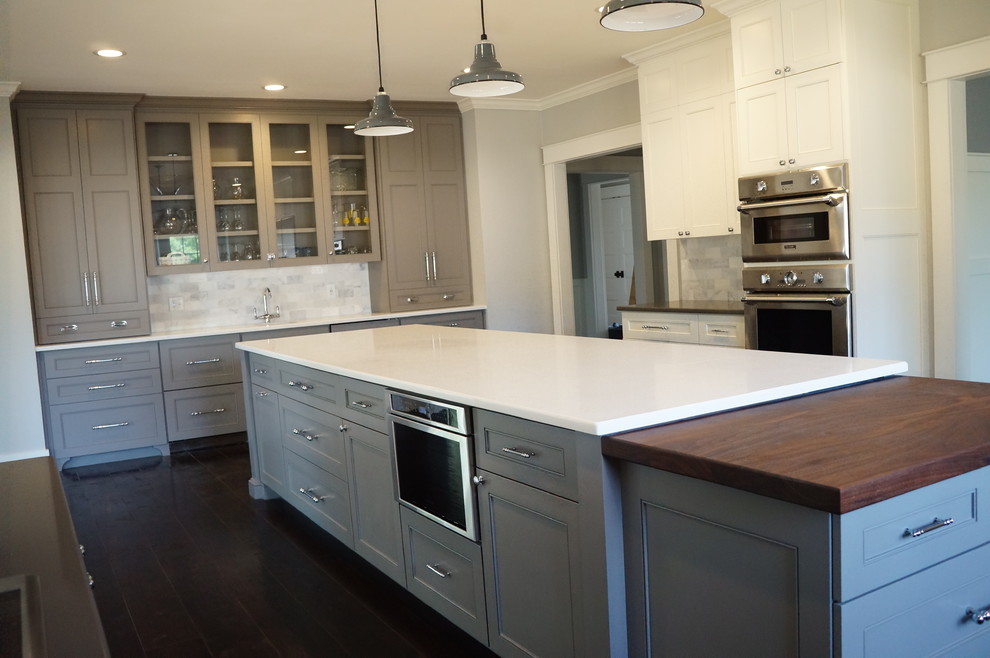 Inspiration for a huge modern u-shaped dark wood floor and black floor enclosed kitchen remodel in Other with a farmhouse sink, recessed-panel cabinets, gray cabinets, quartz countertops, gray backsplash, porcelain backsplash, stainless steel appliances, two islands and white countertops