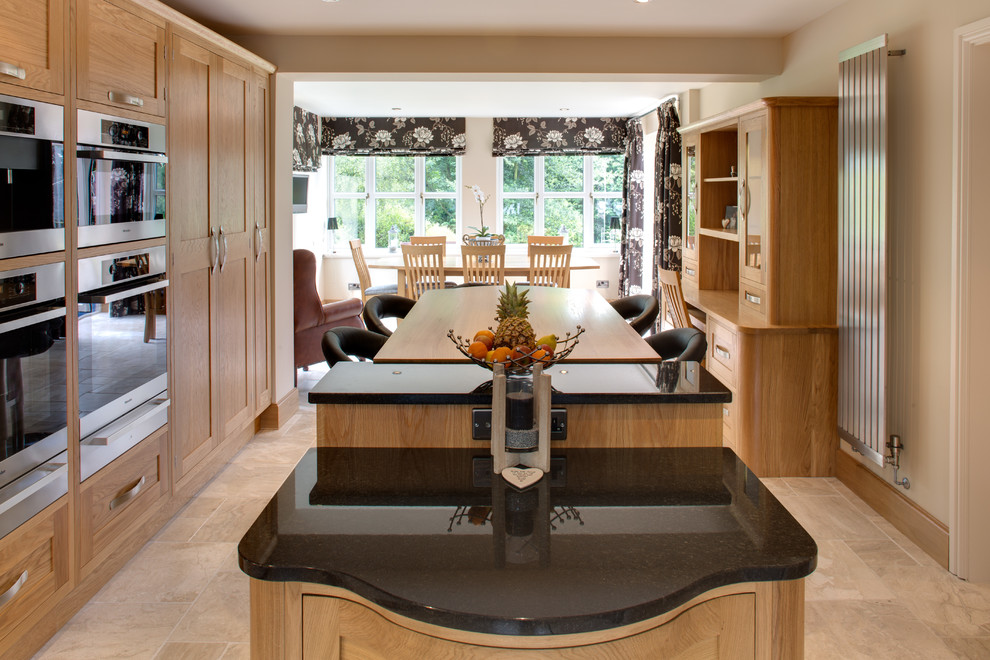 This is an example of a large contemporary u-shaped kitchen/diner in Other with a submerged sink, shaker cabinets, white cabinets, granite worktops, stainless steel appliances and an island.