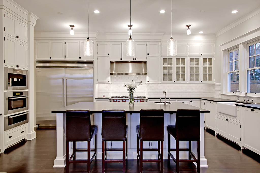 A dark color scheme for the tile backsplash and kitchen countertop