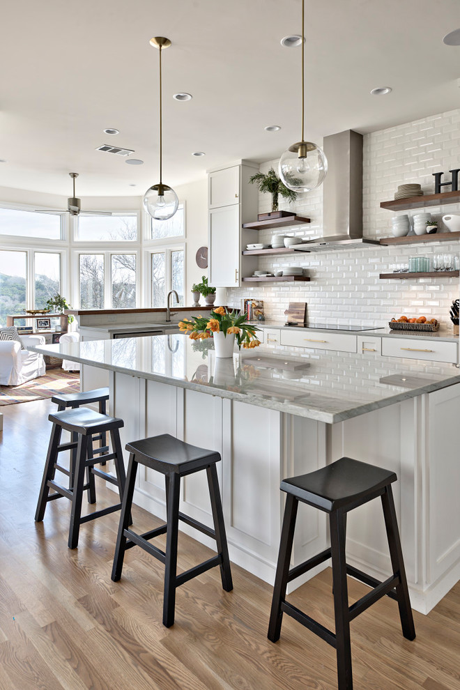 Inspiration for a farmhouse u-shaped medium tone wood floor open concept kitchen remodel in Austin with shaker cabinets, marble countertops, white backsplash, subway tile backsplash and an island