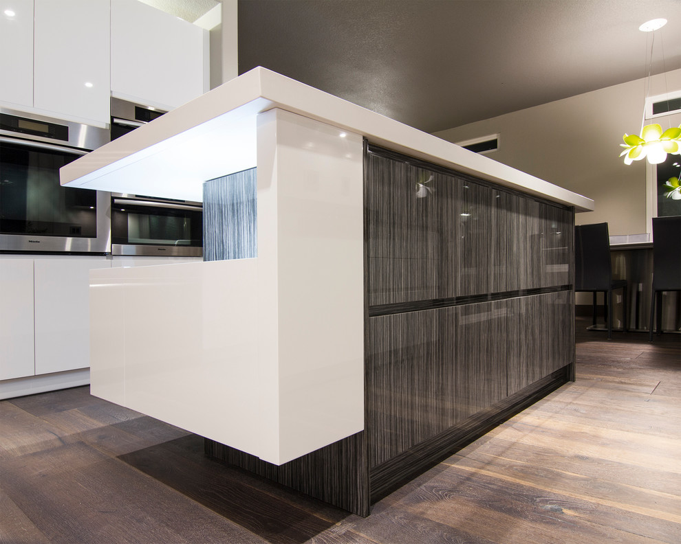 Inspiration for a contemporary u-shaped eat-in kitchen remodel in Los Angeles with an undermount sink, flat-panel cabinets, dark wood cabinets, quartz countertops, white backsplash, porcelain backsplash and stainless steel appliances