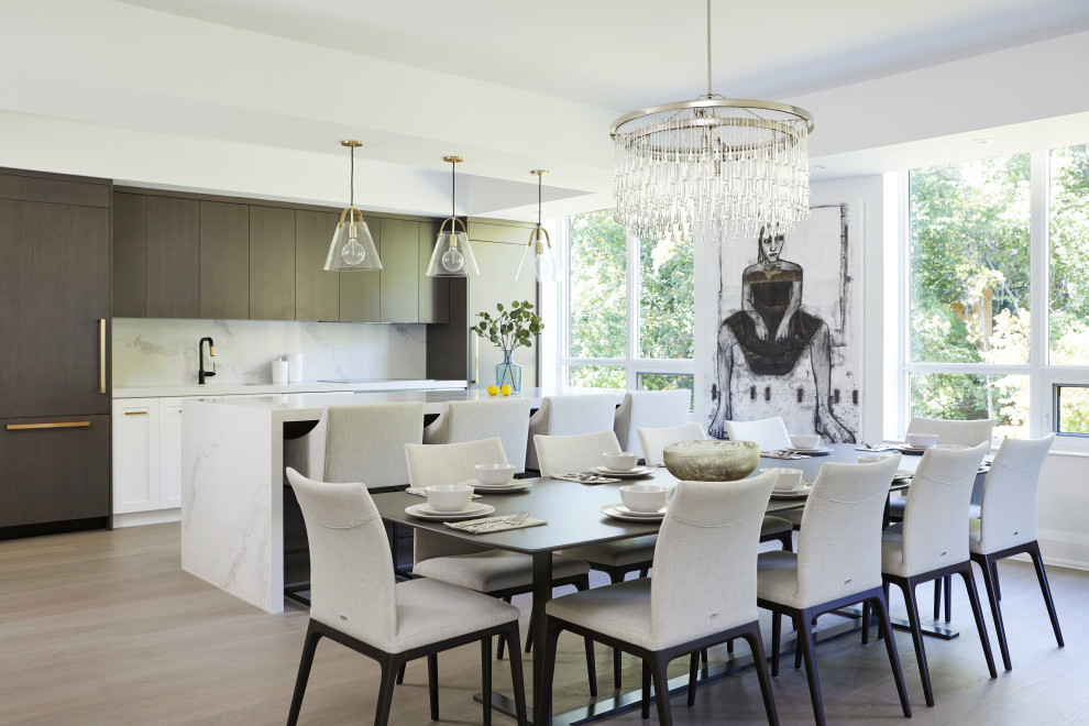 This is an example of a large contemporary single-wall kitchen/diner in Toronto with a submerged sink, flat-panel cabinets, dark wood cabinets, engineered stone countertops, white splashback, integrated appliances, light hardwood flooring, an island and white worktops.