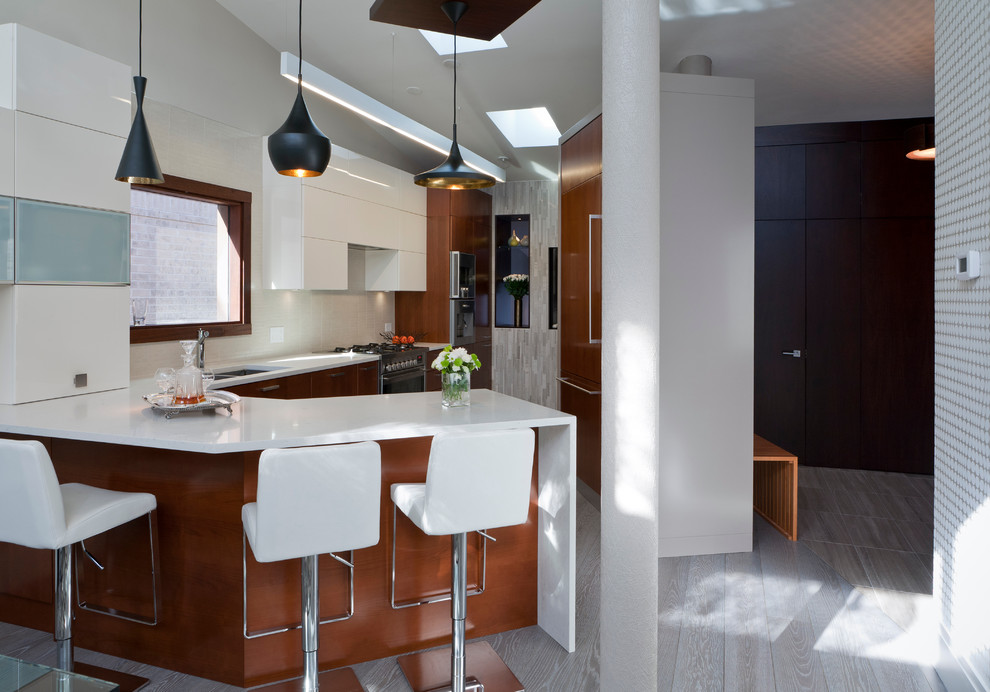 Inspiration for a mid-sized modern l-shaped light wood floor eat-in kitchen remodel in Toronto with an undermount sink, medium tone wood cabinets, quartz countertops, a peninsula, flat-panel cabinets, white backsplash, porcelain backsplash and stainless steel appliances