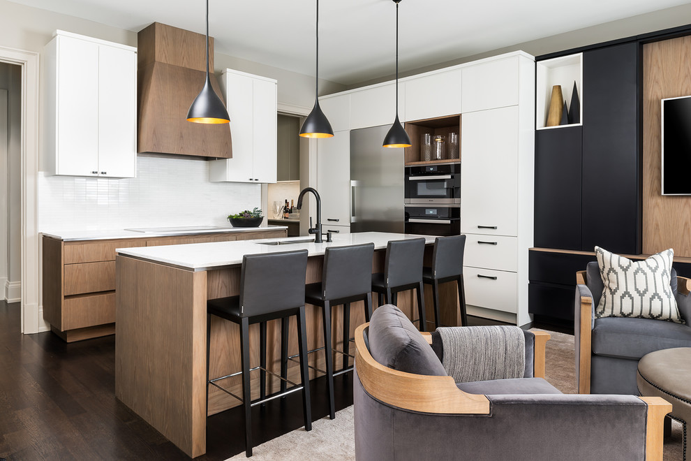 Inspiration for a small contemporary l-shaped open plan kitchen in Toronto with a submerged sink, flat-panel cabinets, light wood cabinets, engineered stone countertops, white splashback, marble splashback, stainless steel appliances, dark hardwood flooring, an island and black floors.