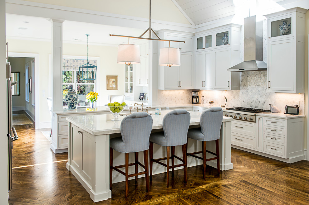 Design ideas for a classic u-shaped kitchen in Atlanta with a submerged sink, stainless steel appliances, an island, shaker cabinets, white cabinets, white splashback, marble splashback, dark hardwood flooring and brown floors.